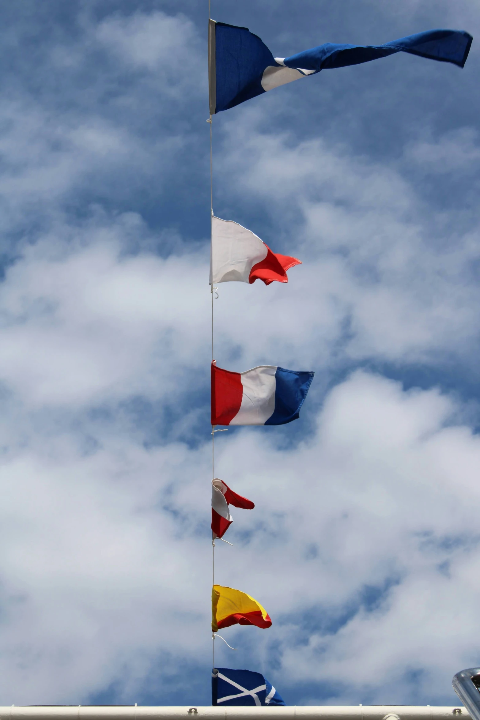 the five flags in the blue sky are flying