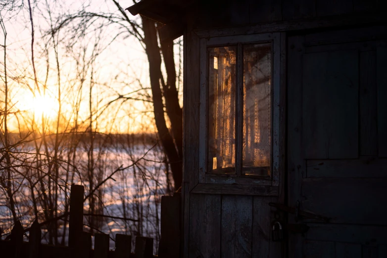 an old door that has the sun in the background