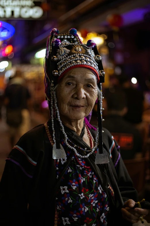 an old chinese woman in a very decorated head dress