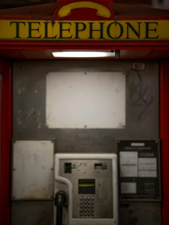 an old fashioned red phone at the gas pump