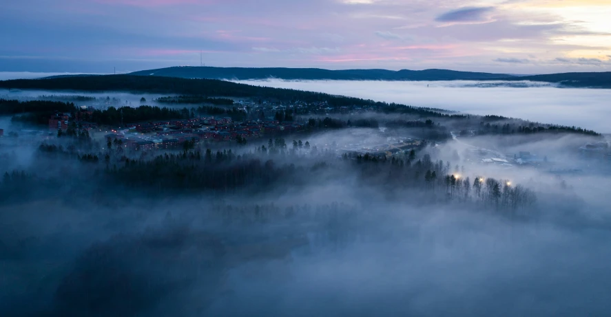 a foggy night with the sun setting