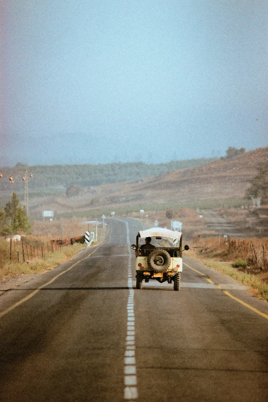 the truck is driving down the empty road