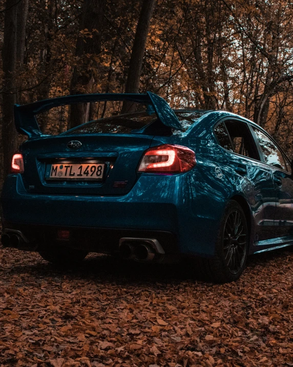 blue bmw c8 parked in the woods at night