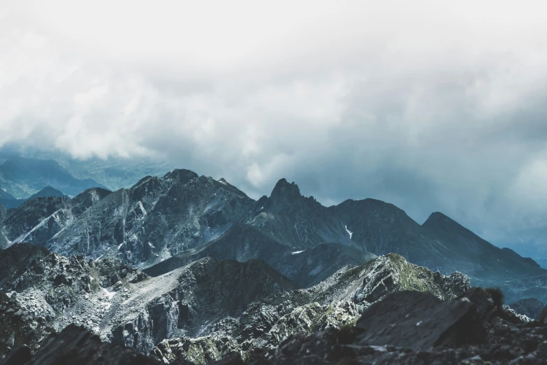 a group of mountain peaks surrounded by snow