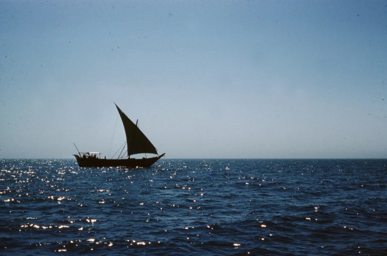 a small boat is sitting in the middle of the ocean