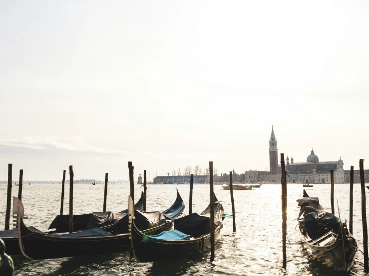 gondolas are tied to poles on a waterway