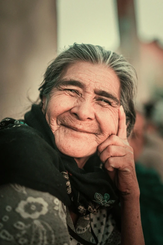 a close up of a person with their hand to her face