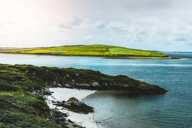 a green island on the side of the water