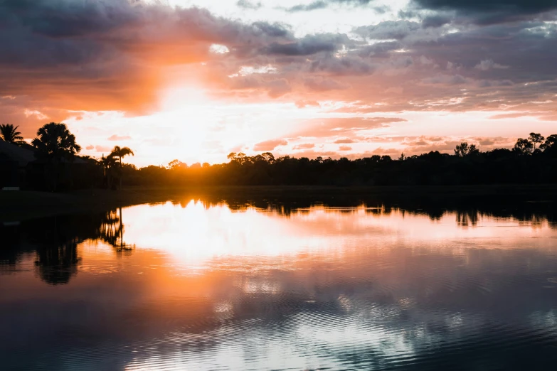 the sun setting over a body of water