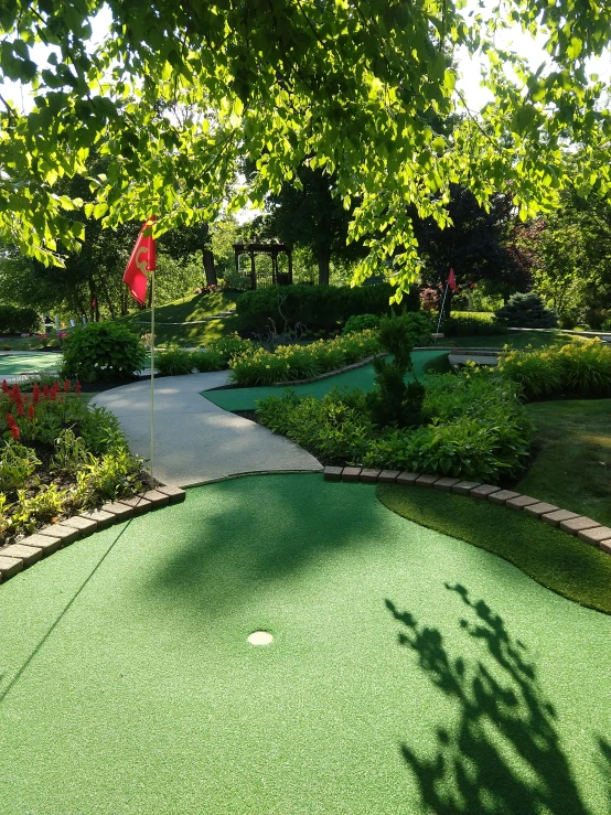 a green, yellow and red golf course in the park