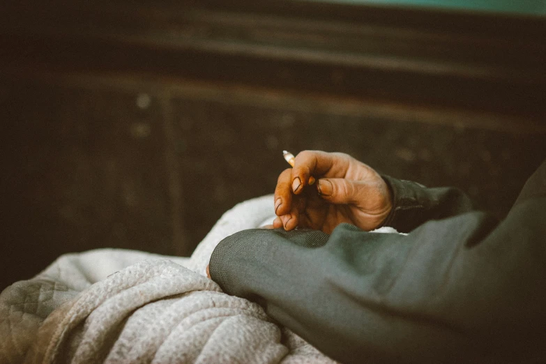 a person sitting down holding a piece of food