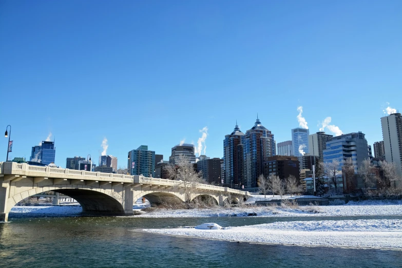 the canadian bridge is spanning over the frozen river