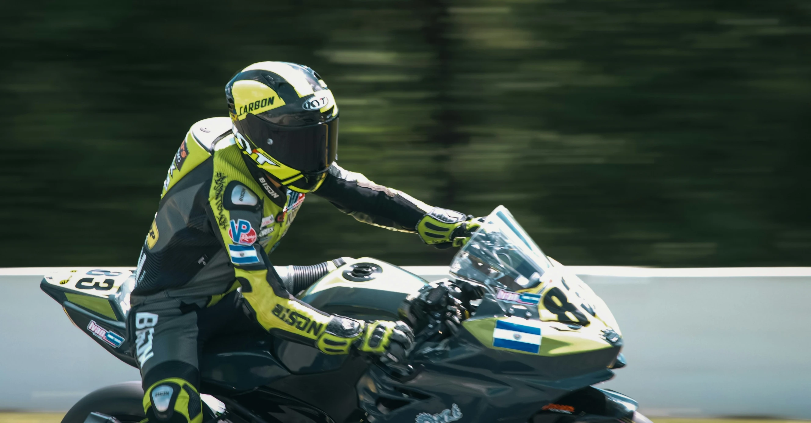 a motorcycle driver races by on his bike