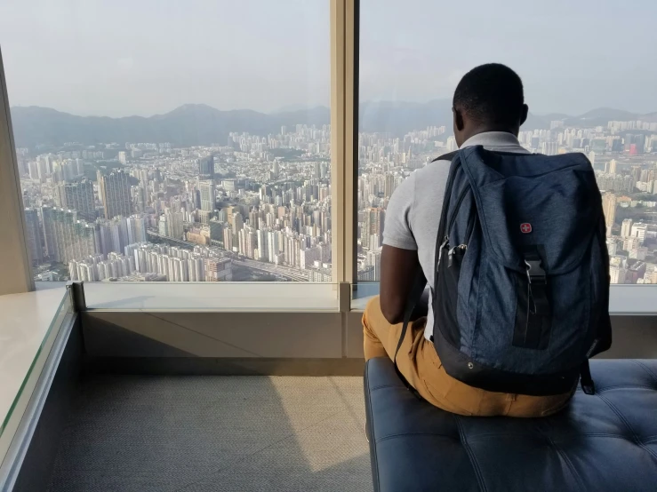 person sitting in an airplane looking out onto a city