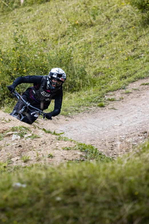 a dirt bike racer coming down a dirt hill