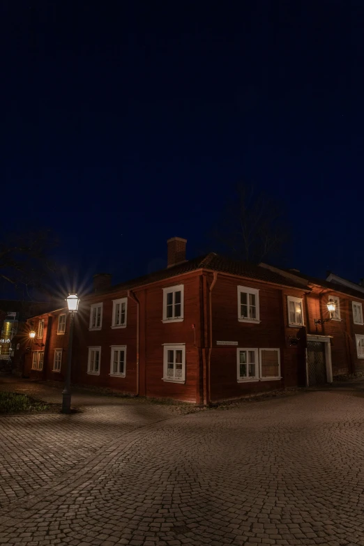 a brick building lit by a street lamp