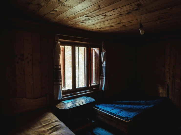 sunlight streaming through the window onto the wooden bed