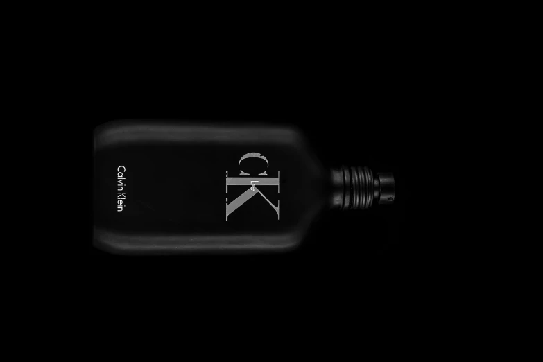 a black bottle that is sitting in the dark