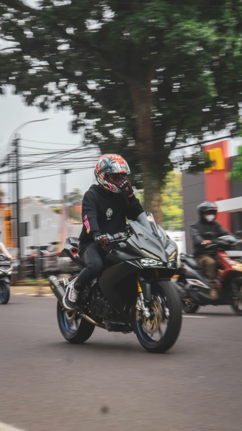 several people on motor bikes driving down the road