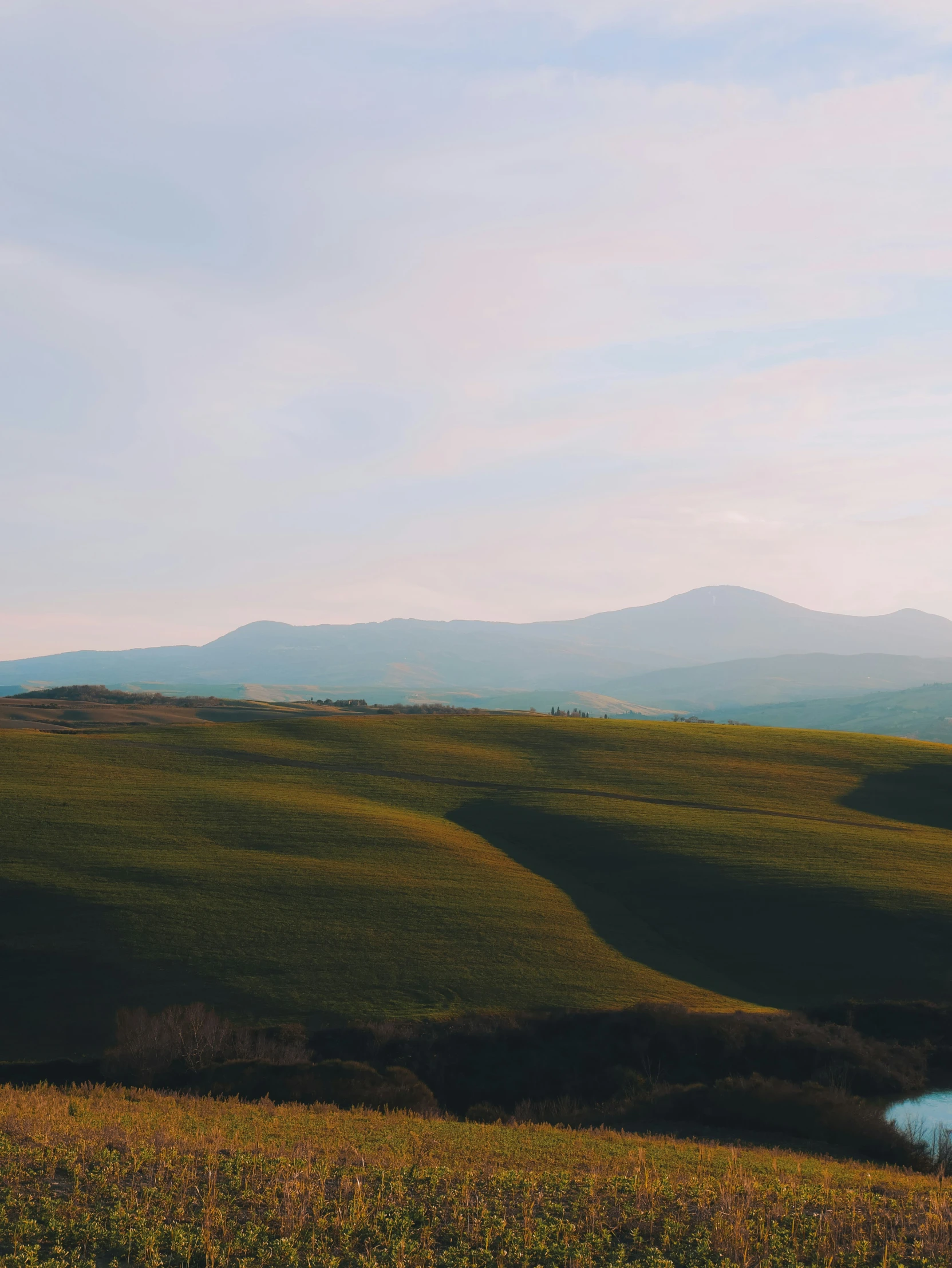 an empty bench sits at the end of a mountain