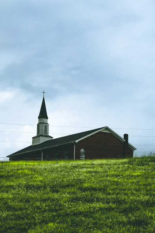 the house with a tower stands alone in the field