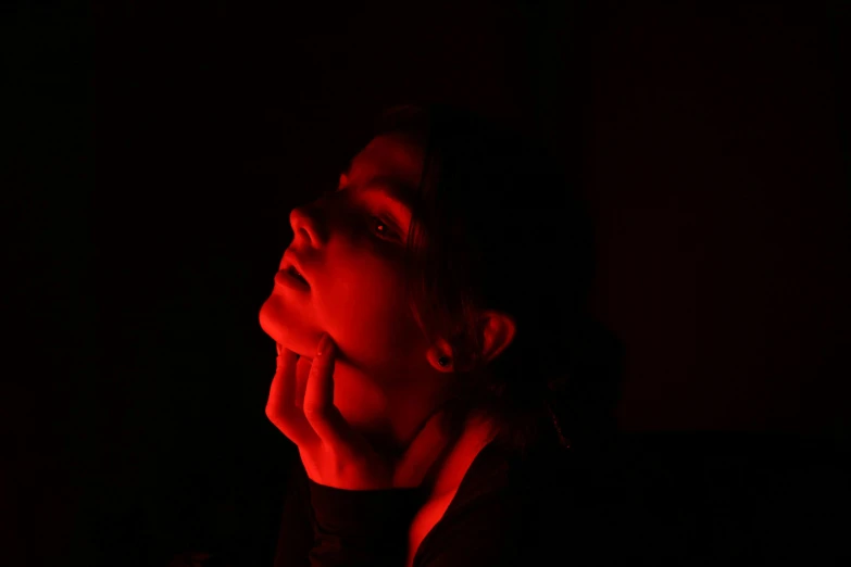 a woman with her face in the dark