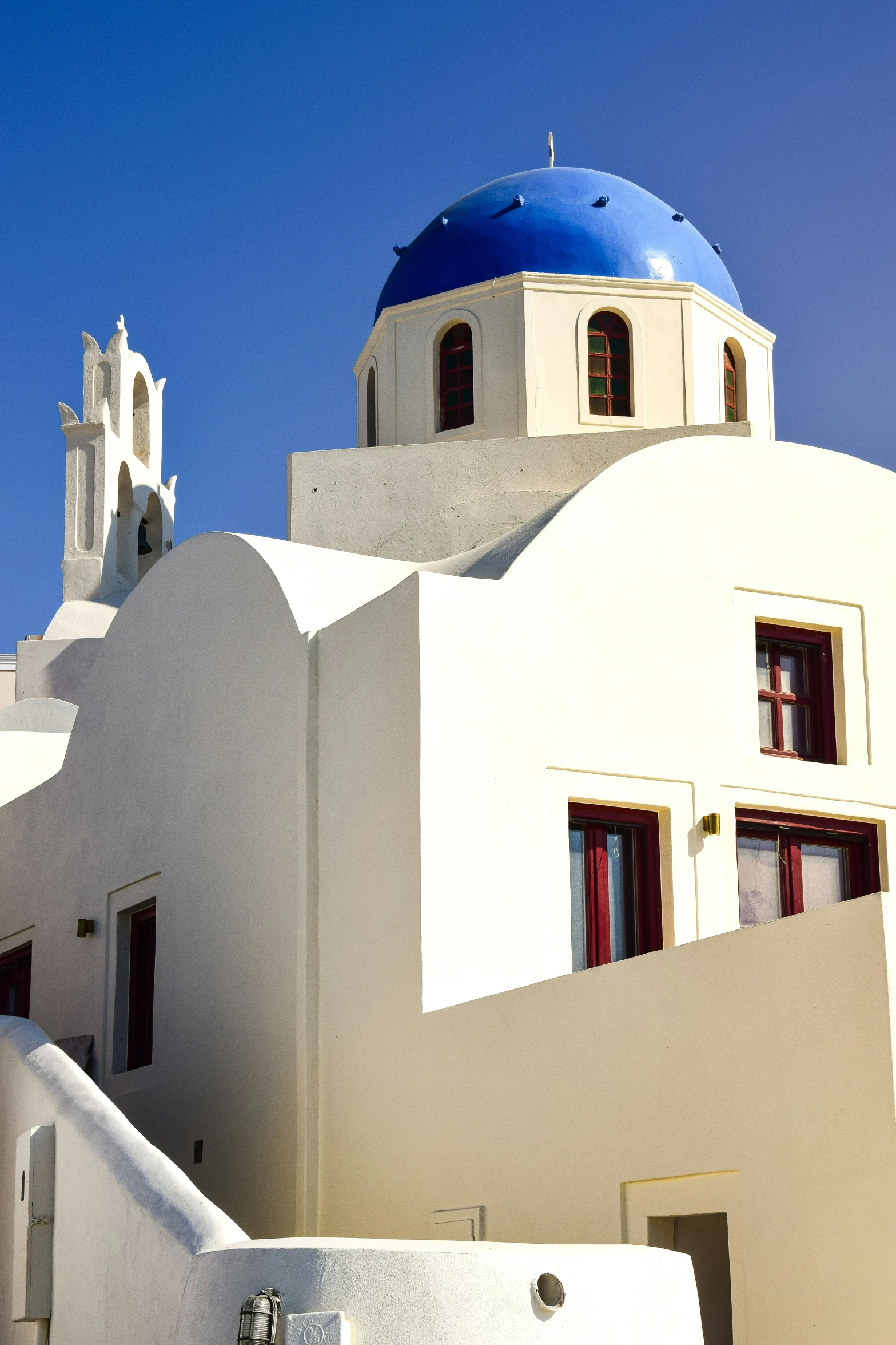 a white building with blue domes and stairs