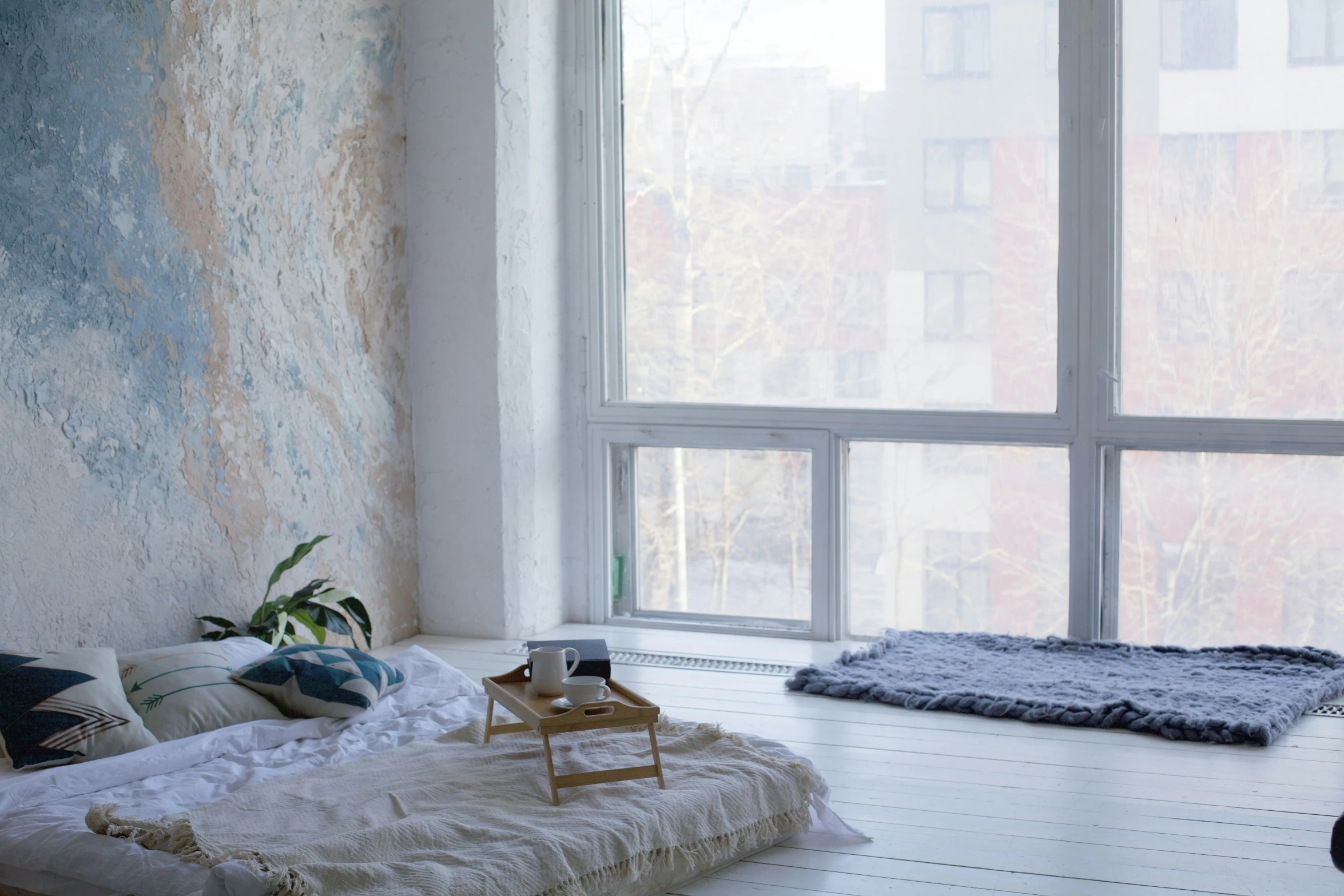 a room with white floors and large windows