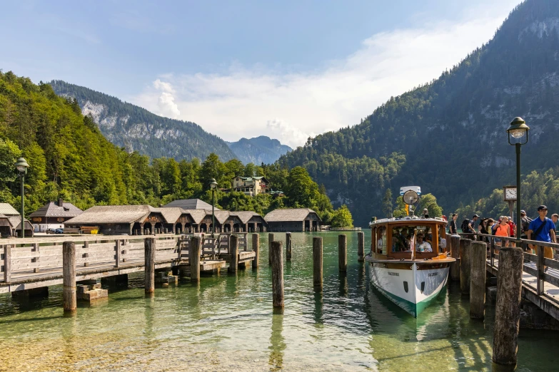 a ferry on a lake with mountains in the background