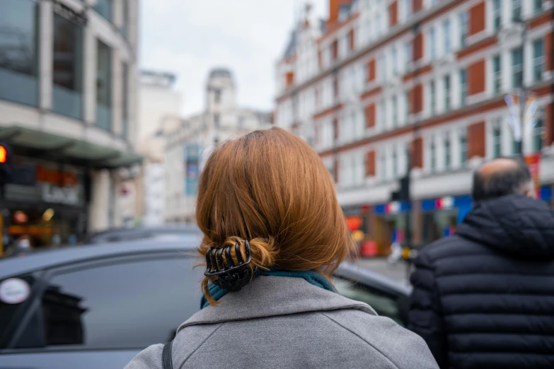 a red headed woman with two ponytails on her hair