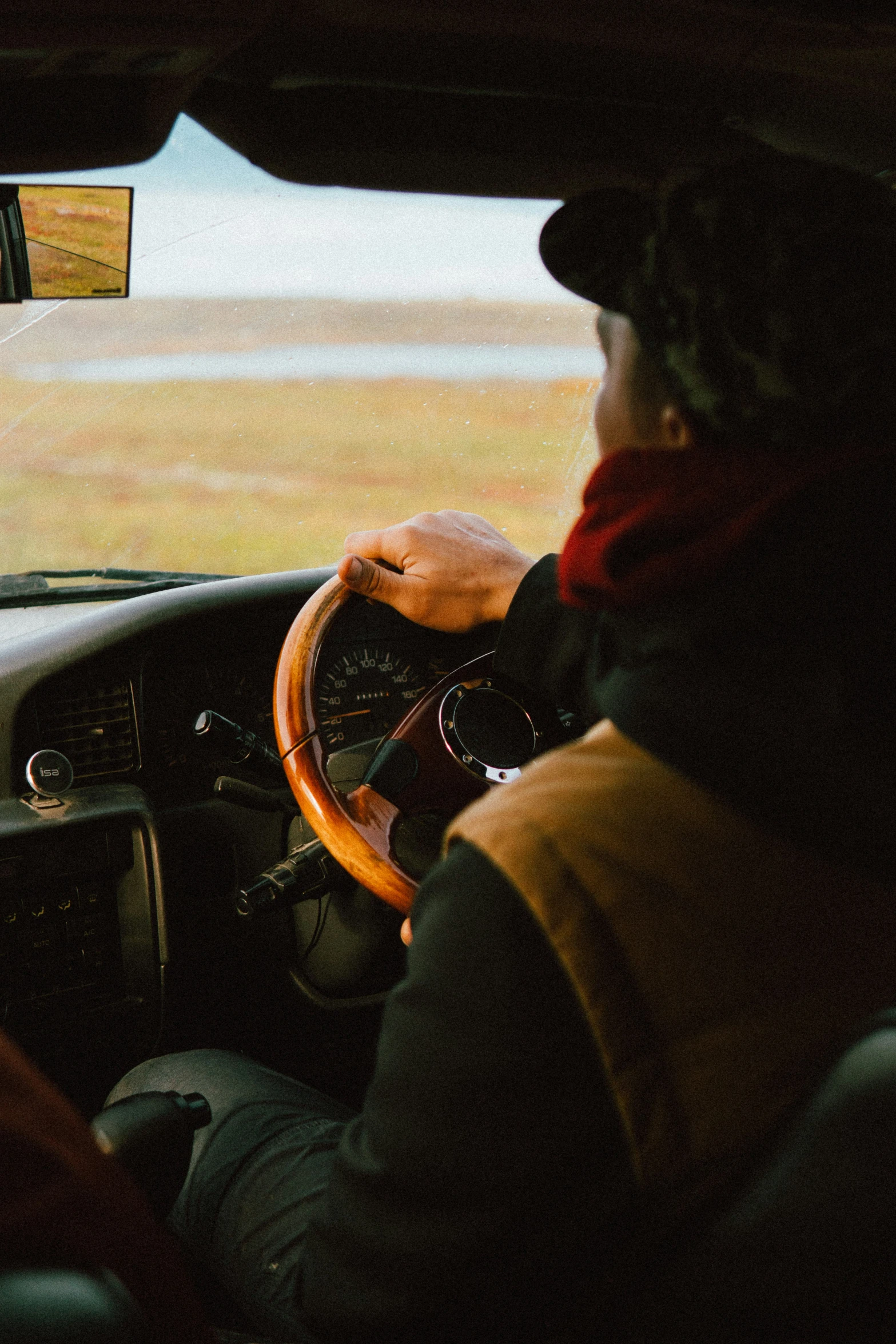 a man driving a car on the open road