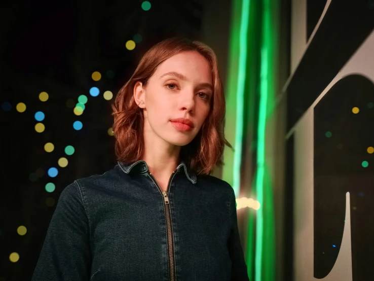 the woman is standing next to a large clock