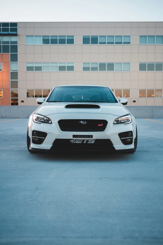 an all white subarunt parked in a parking lot