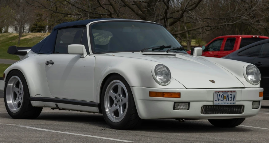 a white sports car is parked on the lot