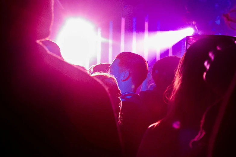 crowd gathered at a bar at night time