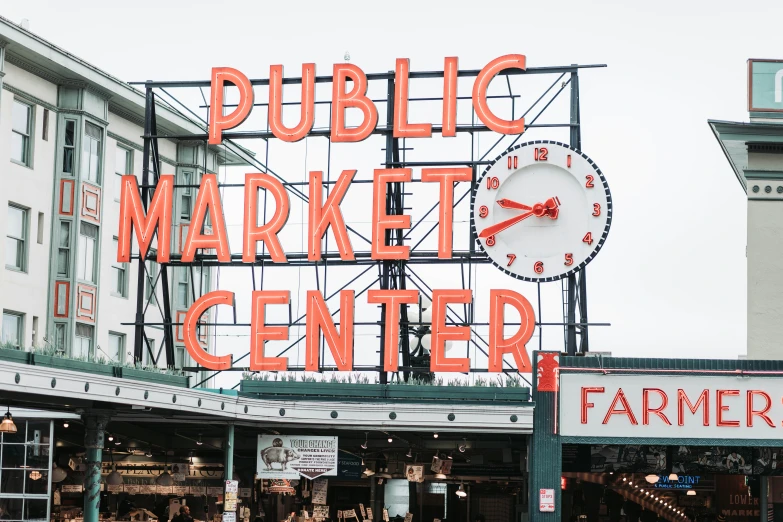 a clock on the sign for the public market center