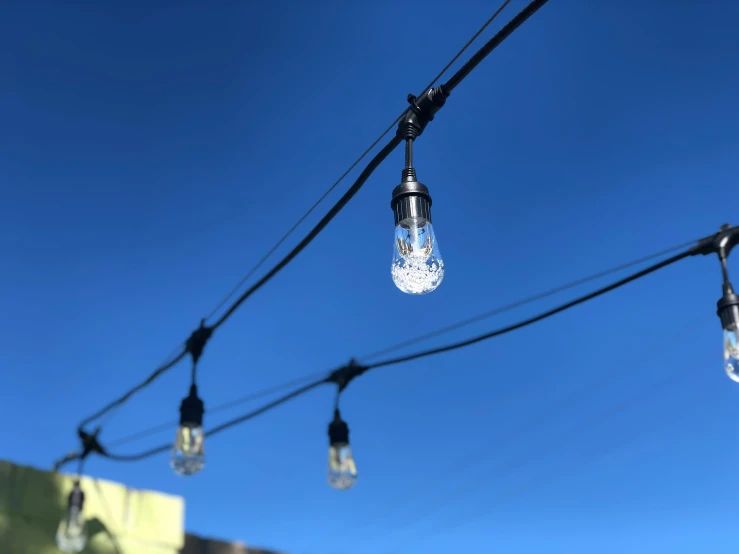 light bulbs hanging in a dark, darkened alley