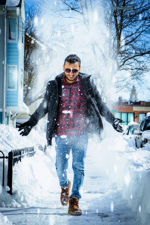 a man walks down a snow covered street during winter