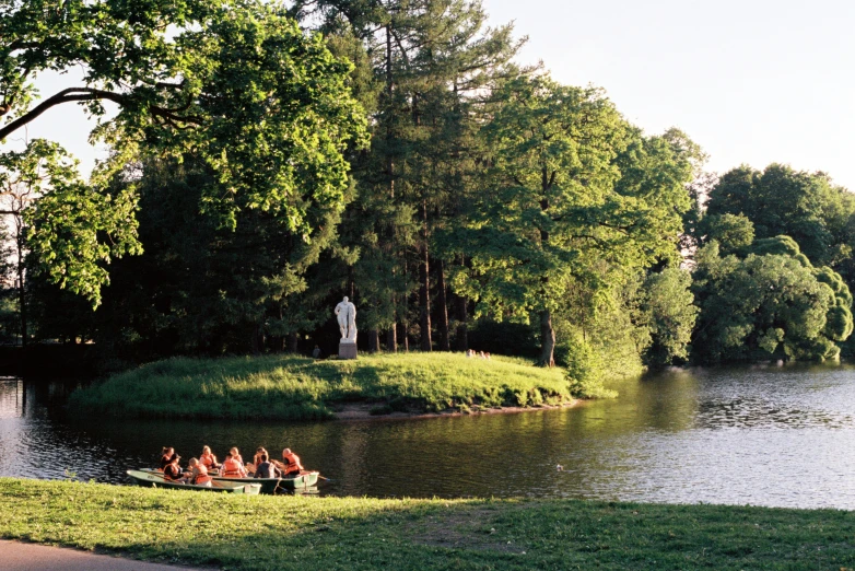 a bunch of people riding on a boat that is near some water