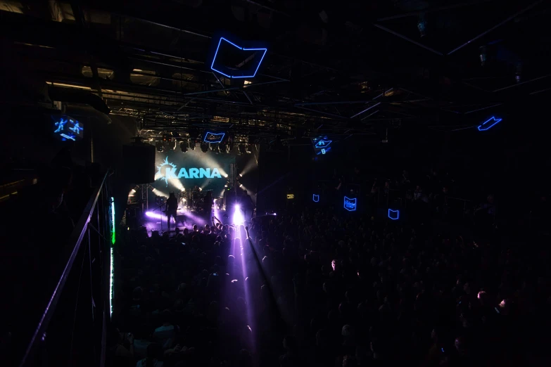 a crowd watching a concert with bright lights