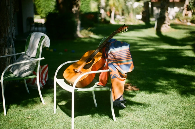 a man with an acoustic guitar is in a chair