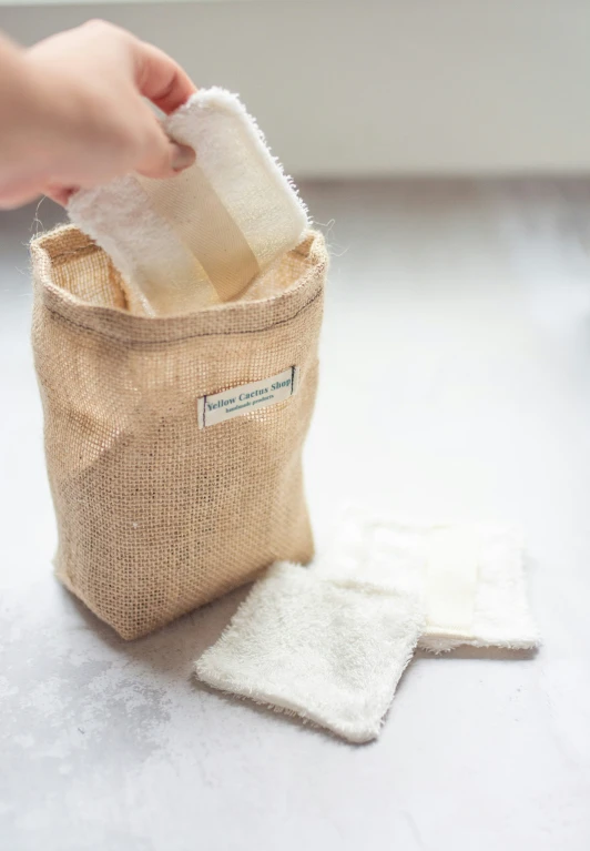 someone removing a napkin from a canvas bag