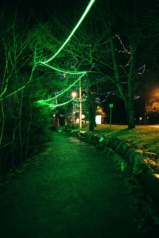 a road lit up at night by many lights