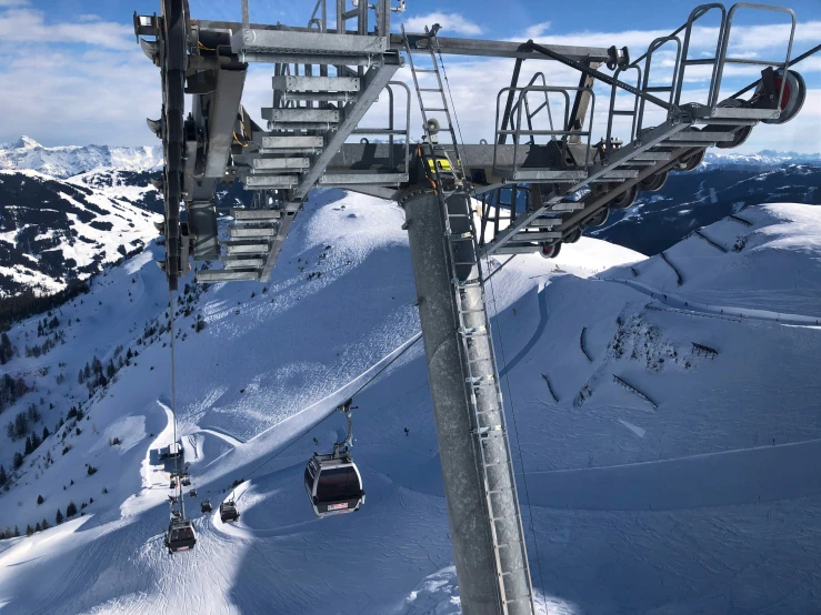 some skiers going up the hill on a ski lift