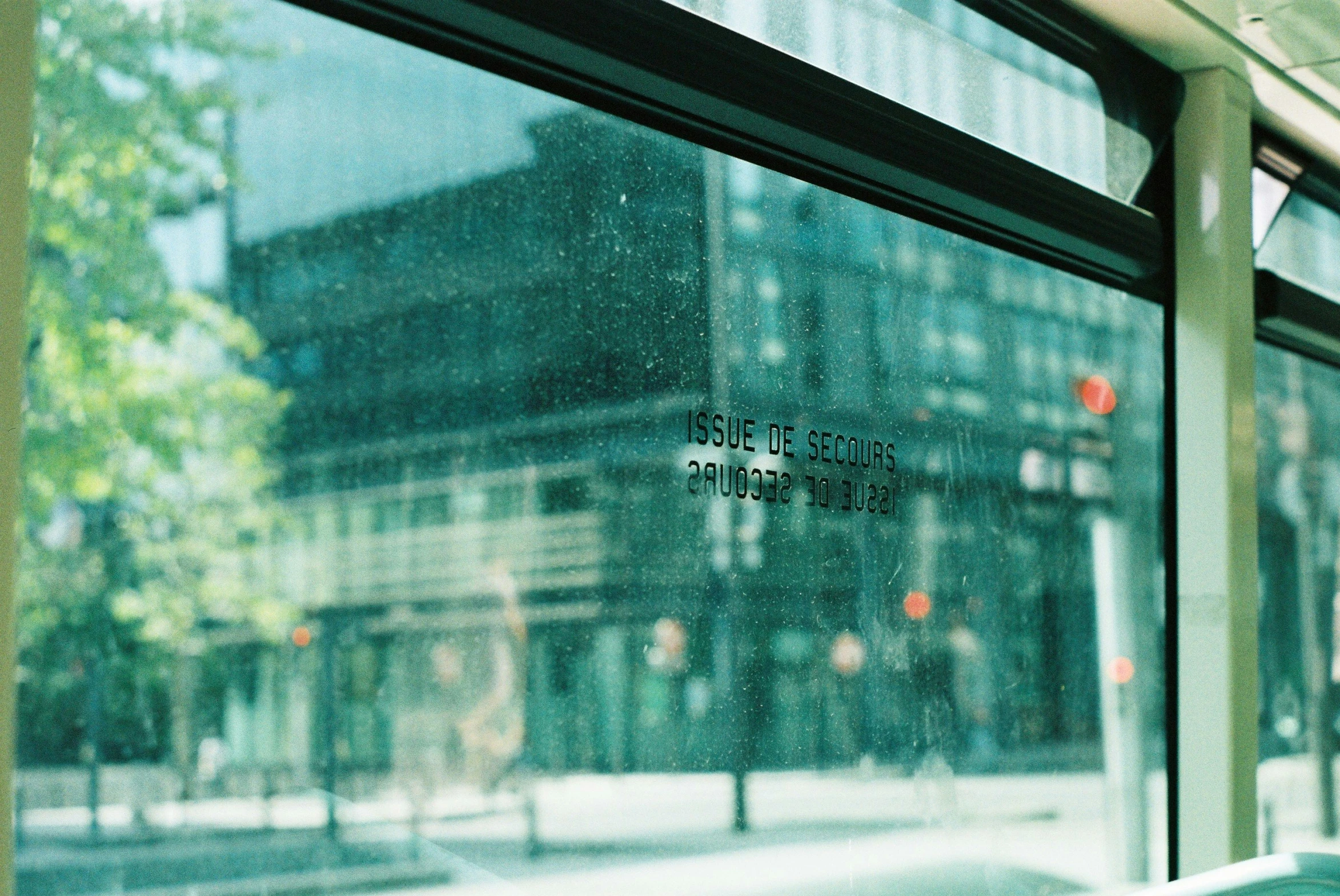 a window with some glass and a blurry building in the background