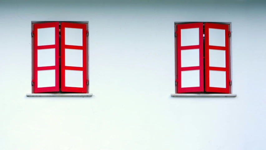 red window frames are shown against a wall