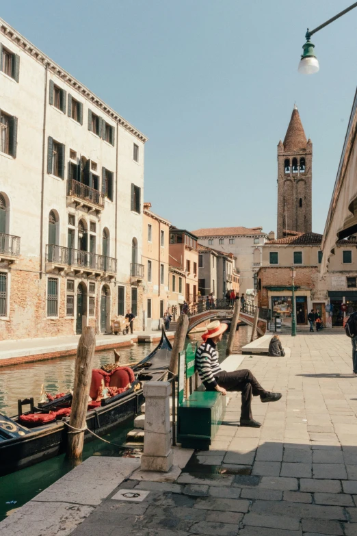 two boats in water with buildings behind them