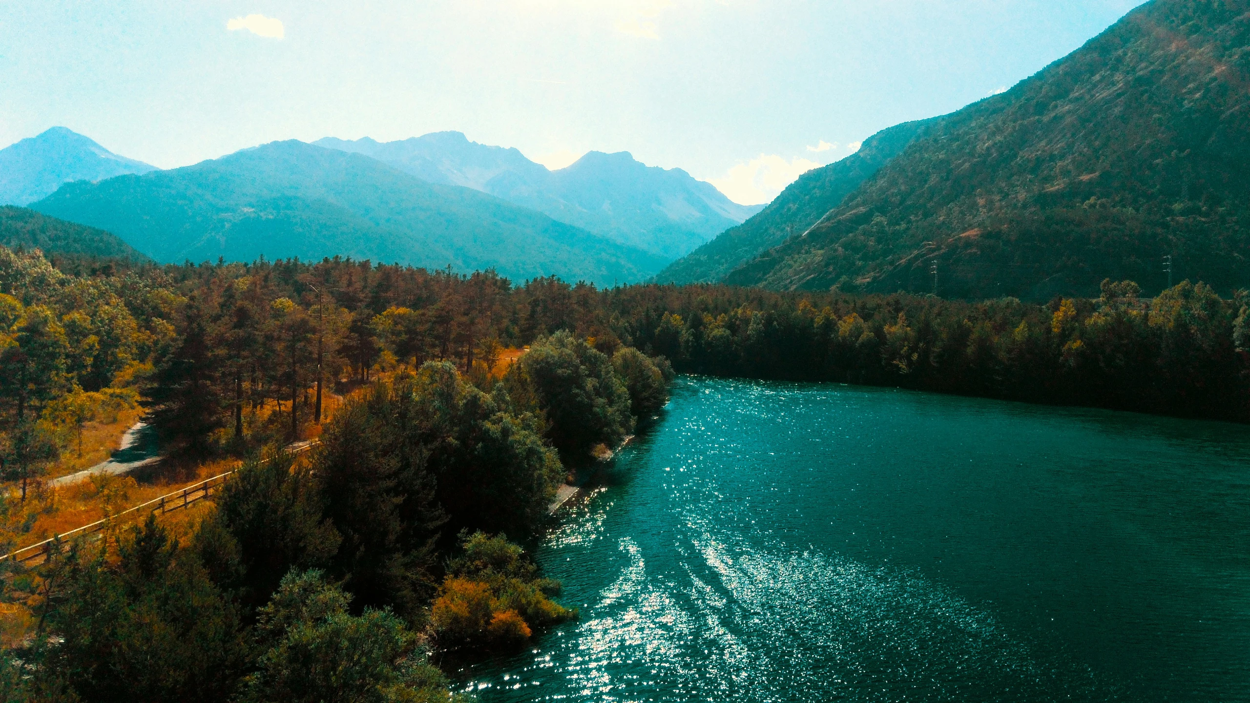 a river cuts through the mountain and flows into a valley