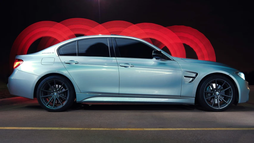 a silver car with lights on the front and dark background