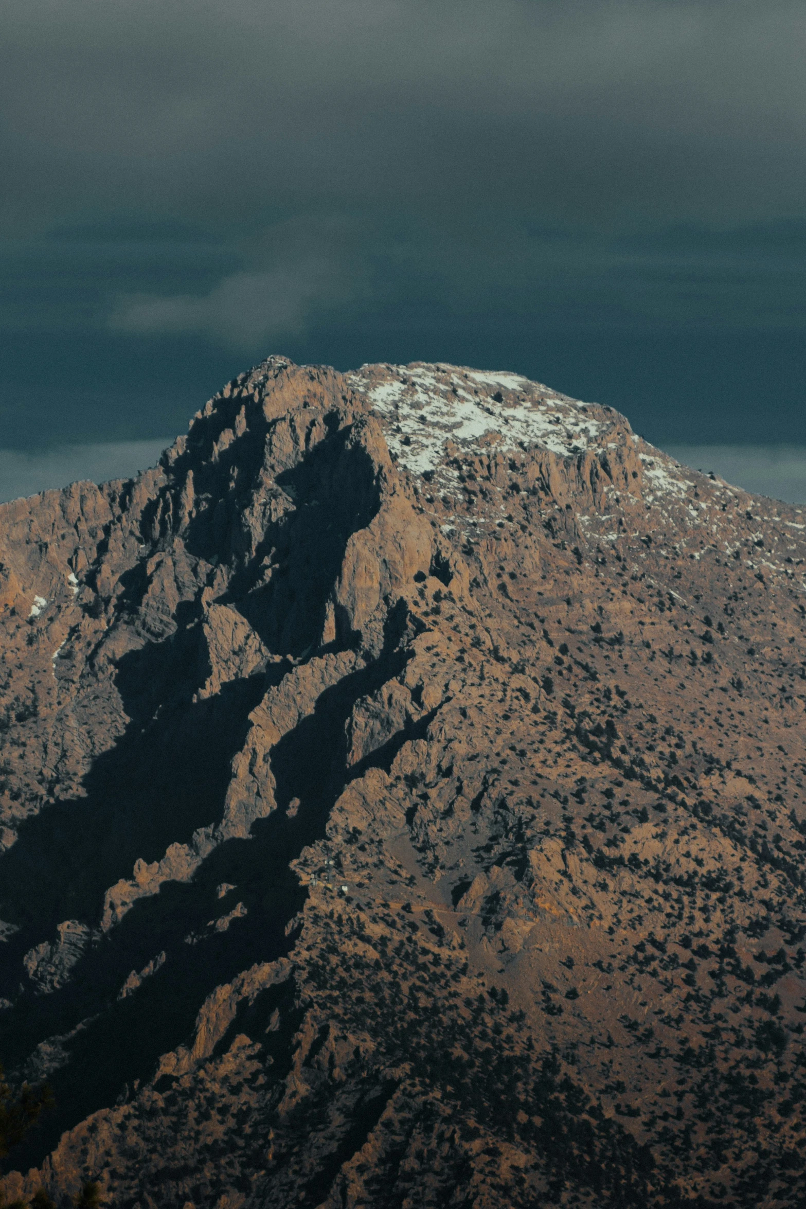 the mountains have snow on them near trees